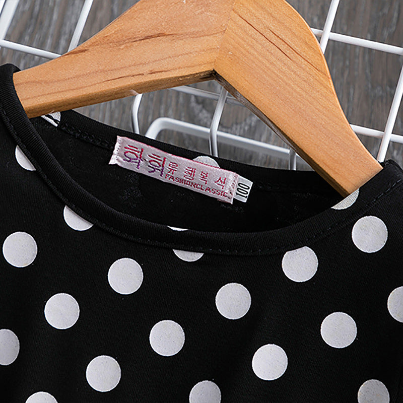Detail of the polka dot print and cotton lining on the Marktox girls' dress