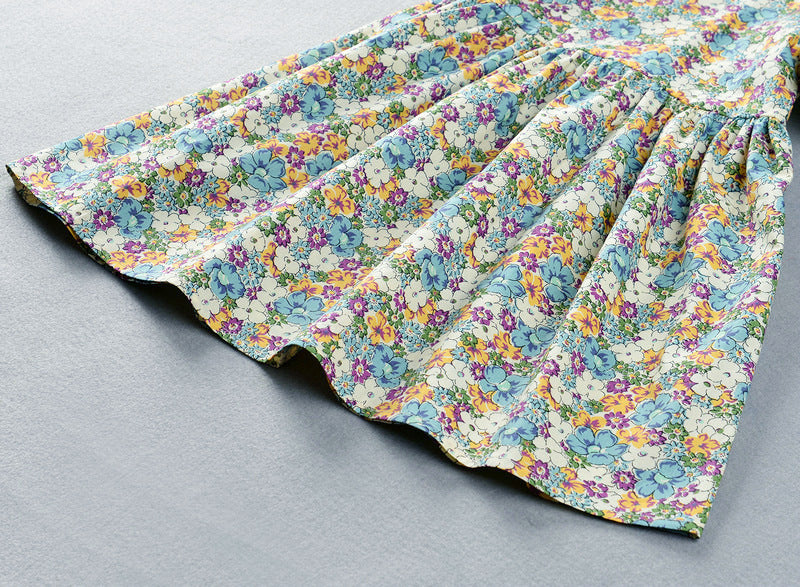 Detail of the green floral print on the Marktox girls' cotton dress