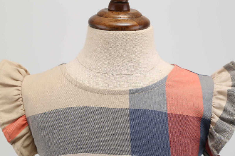 Close-up of the pleated skirt and flutter sleeve on the Marktox girls' orange check dress