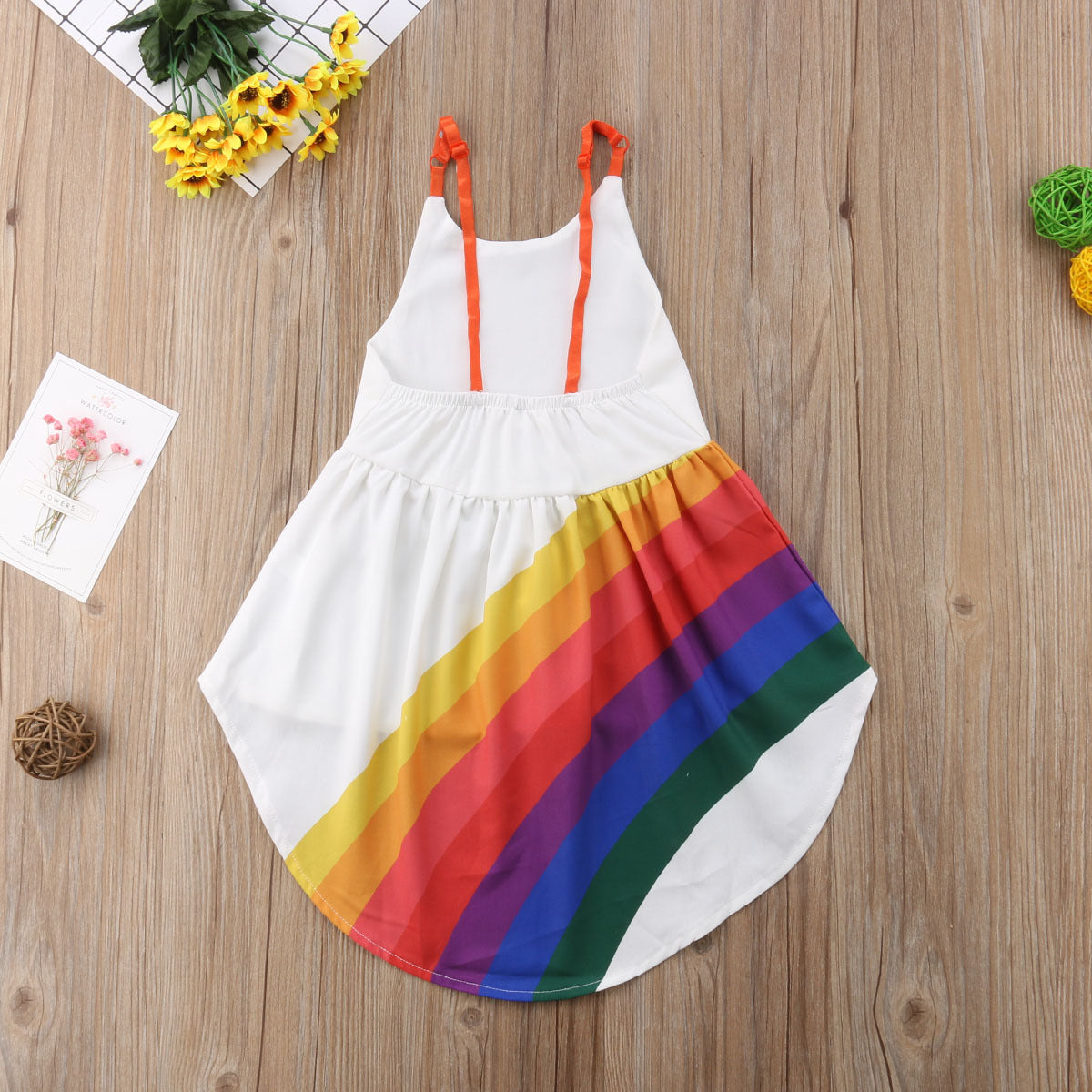 Close-up of the rainbow stripe cotton fabric on the Marktox girls' sleeveless dress