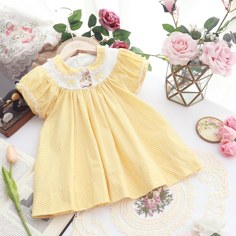 Detail of the skirt and hem on the Marktox girls' yellow plaid embroidered dress