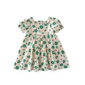 Marktox girls' pleated cotton dress in green floral, shown on a child